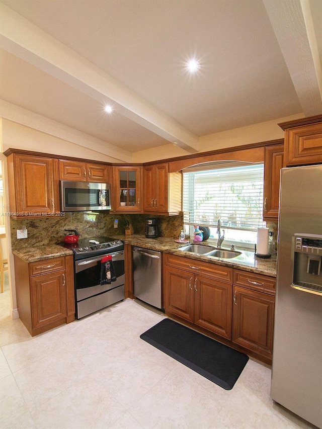 10715 SW 139th Ct, Miami, FL 33186 - kitchen with stainless steel appliances, a sink, brown cabinets, tasteful backsplash, and stone counters