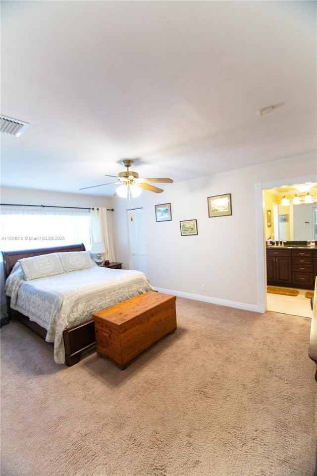 10715 SW 139th Ct, Miami, FL 33186 - bedroom with light colored carpet, baseboards, connected bathroom, and ceiling fan