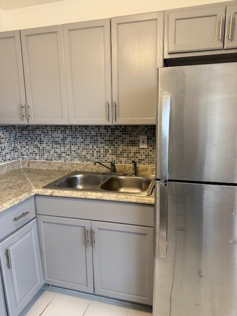 505 NW 177th St Unit 136, Miami Gardens, FL 33169 - kitchen with freestanding refrigerator, a sink, gray cabinets, and light countertops