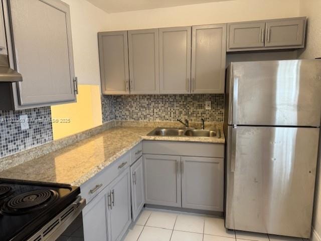 505 NW 177th St Unit 136, Miami Gardens, FL 33169 - kitchen with freestanding refrigerator, gray cabinetry, a sink, and decorative backsplash