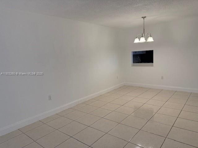505 NW 177th St Unit 136, Miami Gardens, FL 33169 - unfurnished room with a chandelier, light tile patterned flooring, and baseboards
