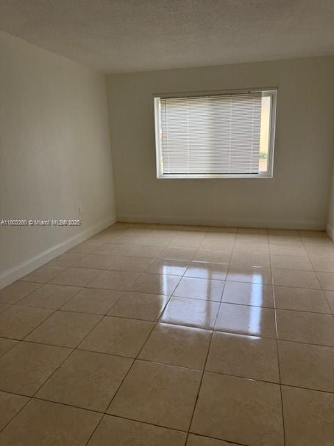 505 NW 177th St Unit 136, Miami Gardens, FL 33169 - unfurnished room with healthy amount of natural light, light tile patterned flooring, and baseboards