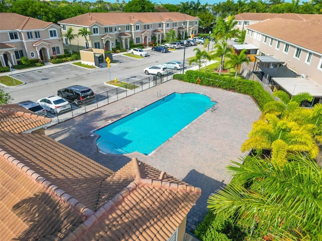 1056 SE 24th Ave, Homestead, FL 33035 - community pool featuring a residential view and fence