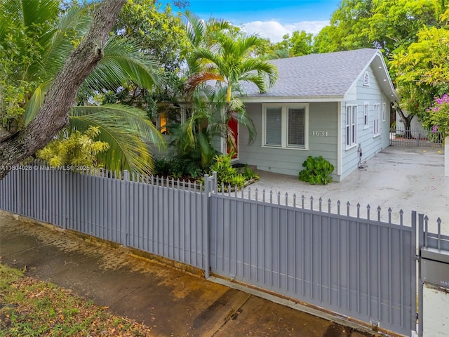 1631 SW 11th St, Miami, FL 33135 - view of front of home featuring roof with shingles and a fenced front yard