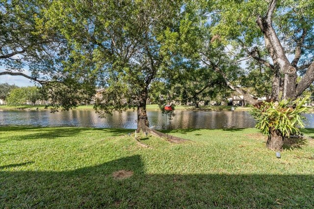 1150 NW 99th Ave Unit 69, Pembroke Pines, FL 33024 - view of green lawn with a water view