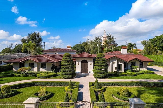 3310 Granada Blvd, Coral Gables, FL 33134 - mediterranean / spanish home featuring stucco siding, a tiled roof, and a chimney