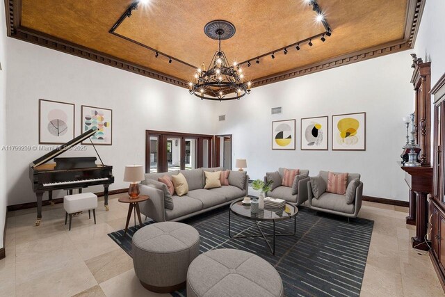 3310 Granada Blvd, Coral Gables, FL 33134 - living area with track lighting, baseboards, a high ceiling, and a chandelier