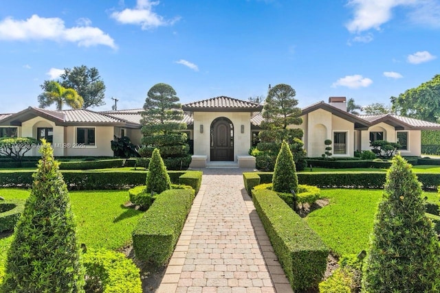 3310 Granada Blvd, Coral Gables, FL 33134 - mediterranean / spanish-style house featuring stucco siding, a chimney, and a front yard