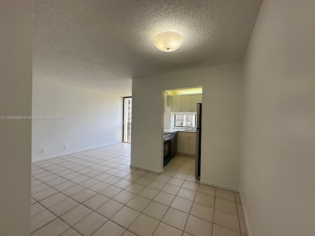 16919 N Bay Rd Unit 617, Sunny Isles Beach, FL 33160 - spare room featuring a textured ceiling, light tile patterned floors, baseboards, and a sink