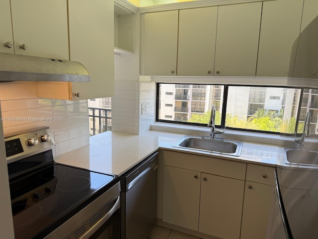 16919 N Bay Rd Unit 617, Sunny Isles Beach, FL 33160 - kitchen with stainless steel appliances, a sink, under cabinet range hood, and light countertops