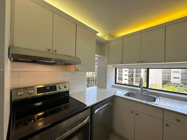 16919 N Bay Rd Unit 617, Sunny Isles Beach, FL 33160 - kitchen featuring appliances with stainless steel finishes, a sink, under cabinet range hood, backsplash, and light countertops