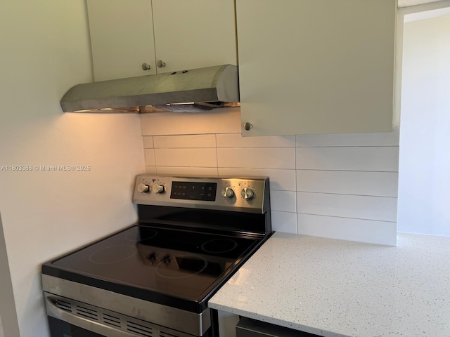 16919 N Bay Rd Unit 617, Sunny Isles Beach, FL 33160 - kitchen with stainless steel electric range oven, ventilation hood, backsplash, and light stone counters