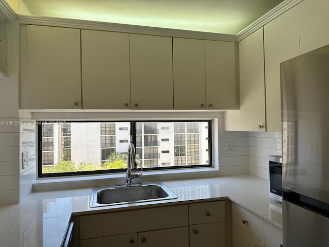 16919 N Bay Rd Unit 617, Sunny Isles Beach, FL 33160 - kitchen featuring stainless steel appliances, a sink, backsplash, and cream cabinets