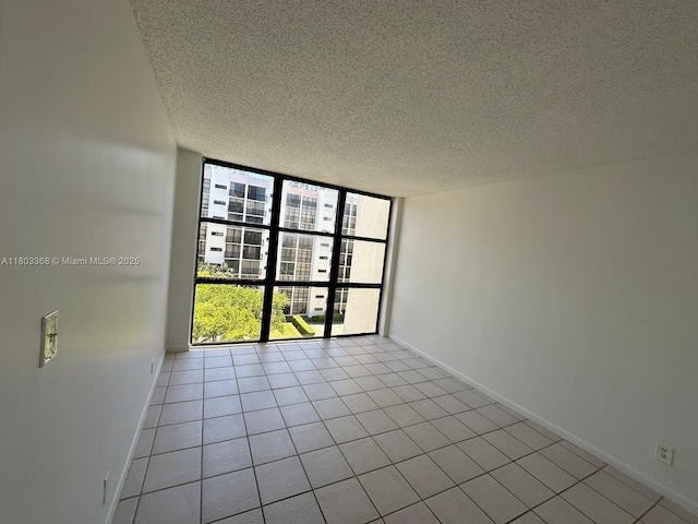 16919 N Bay Rd Unit 617, Sunny Isles Beach, FL 33160 - unfurnished room featuring a textured ceiling, floor to ceiling windows, light tile patterned flooring, and baseboards