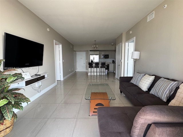 2600 E Hallandale Beach Blvd Unit T3210, Hallandale Beach, FL 33009 - living room with a chandelier, light tile patterned flooring, and baseboards