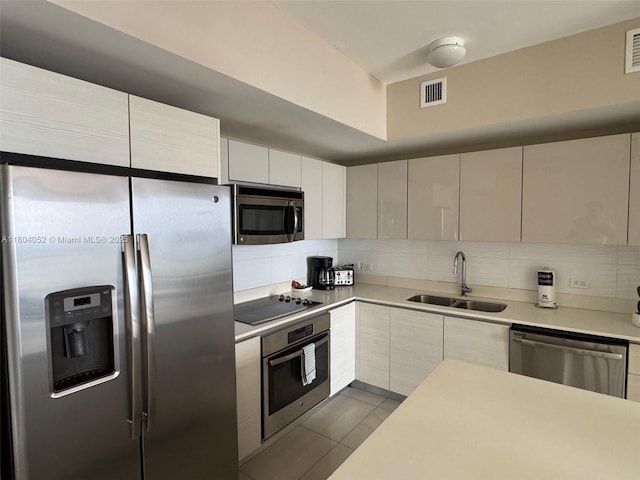 2600 E Hallandale Beach Blvd Unit T3210, Hallandale Beach, FL 33009 - kitchen with stainless steel appliances, a sink, decorative backsplash, light countertops, and dark tile patterned floors