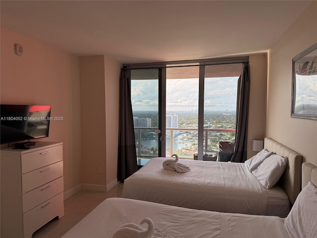 2600 E Hallandale Beach Blvd Unit T3210, Hallandale Beach, FL 33009 - bedroom featuring light tile patterned flooring, expansive windows, and baseboards