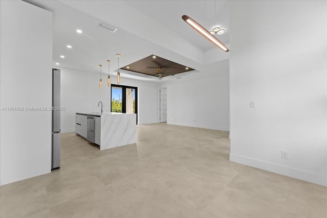4623 7th St W, Lehigh Acres, FL 33971 - unfurnished living room featuring a raised ceiling, recessed lighting, a sink, finished concrete flooring, and baseboards