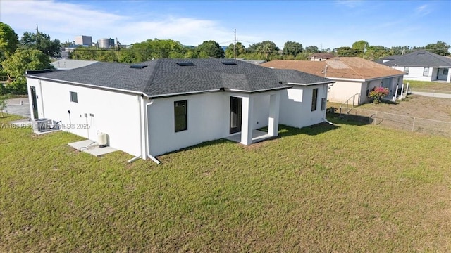 4623 7th St W, Lehigh Acres, FL 33971 - rear view of property with stucco siding and a shingled roof