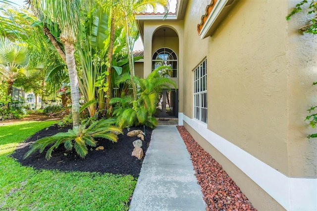 doorway to property featuring stucco siding and french doors