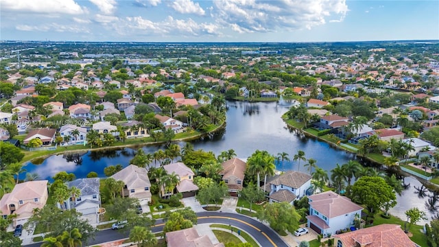 aerial view of residential area featuring a large body of water