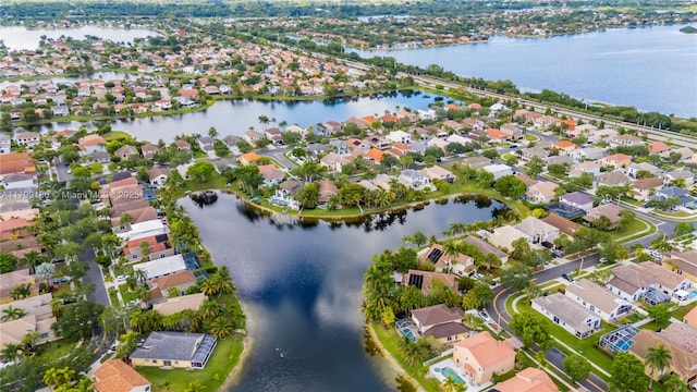 aerial view of property's location with nearby suburban area and a large body of water