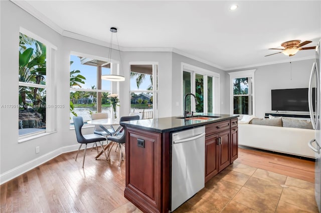 kitchen featuring a sink, stainless steel dishwasher, healthy amount of natural light, crown molding, and pendant lighting