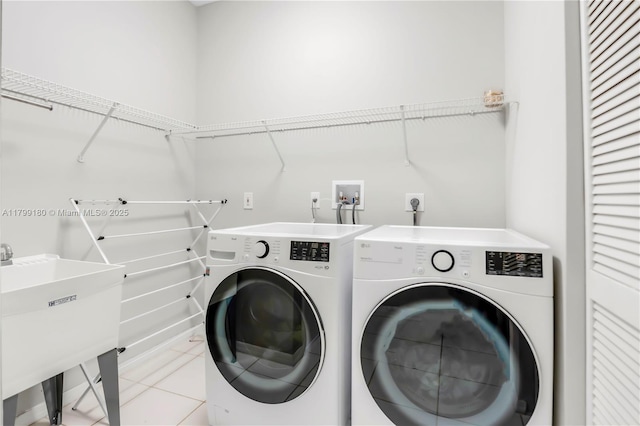 washroom with washer and dryer and tile patterned floors