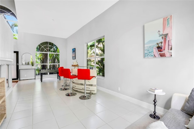 dining space with baseboards and tile patterned floors