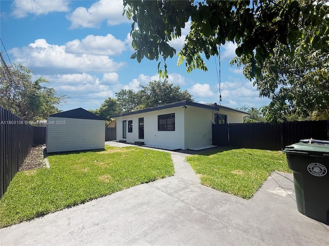5741 SW 13th St, Miami, FL 33144 - back of house featuring an outdoor structure, stucco siding, a patio, and a storage unit