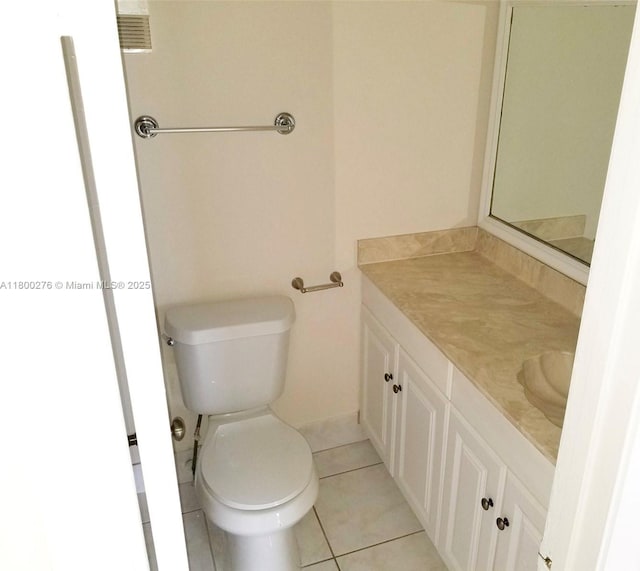 bathroom featuring vanity, tile patterned floors, and toilet