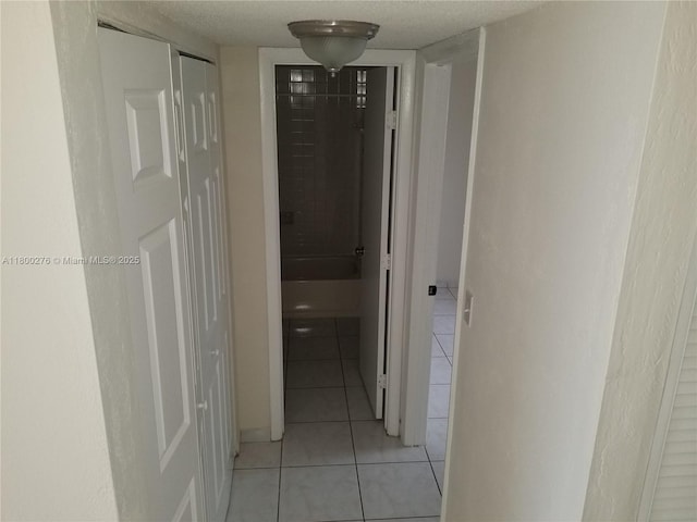 corridor with light tile patterned flooring