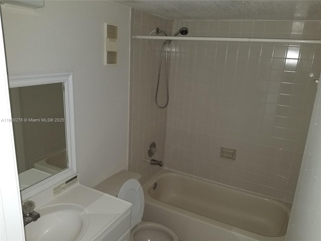 bathroom featuring shower / bathtub combination, toilet, and vanity