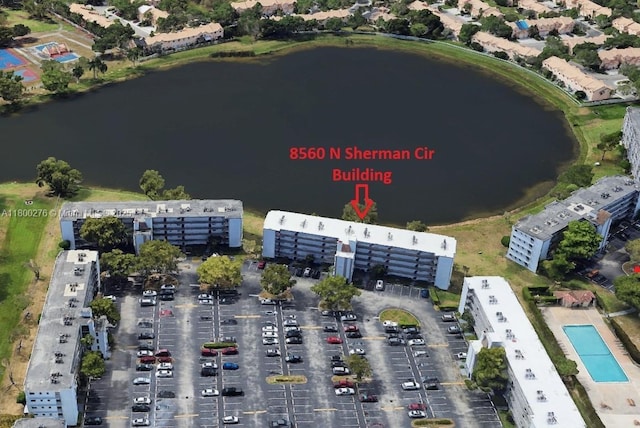 aerial view of property's location featuring a nearby body of water and apartment complex