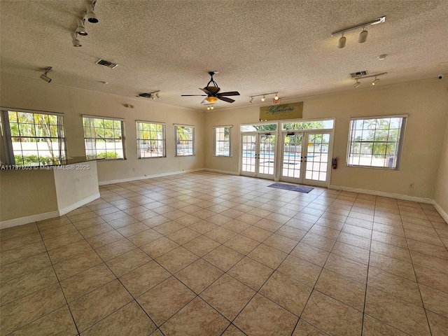 2151 NW 96th Ter Unit 15L, Pembroke Pines, FL 33024 - tiled spare room featuring track lighting, healthy amount of natural light, a ceiling fan, and a textured ceiling