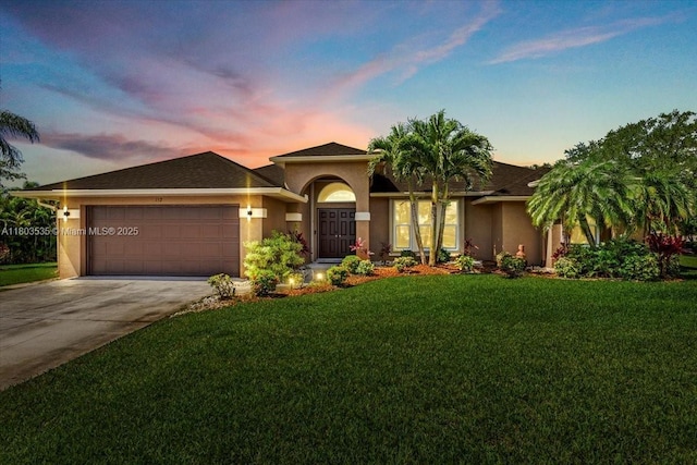 112 SW N Danville Cir, Port St Lucie, FL 34953 - view of front of property featuring an attached garage, driveway, a front yard, and stucco siding