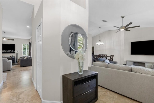 112 SW N Danville Cir, Port St Lucie, FL 34953 - living room featuring a ceiling fan, plenty of natural light, vaulted ceiling, a chandelier, and baseboards