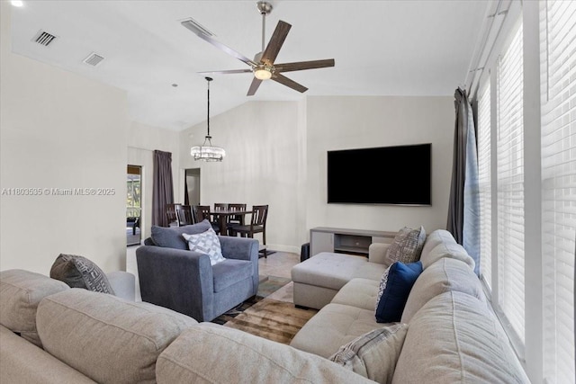112 SW N Danville Cir, Port St Lucie, FL 34953 - living room featuring a chandelier, ceiling fan, vaulted ceiling, and baseboards