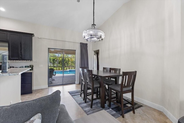 112 SW N Danville Cir, Port St Lucie, FL 34953 - dining area featuring a chandelier, baseboards, and high vaulted ceiling