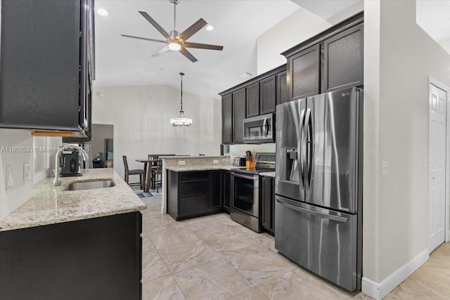 112 SW N Danville Cir, Port St Lucie, FL 34953 - kitchen with stainless steel appliances, a sink, a ceiling fan, light stone countertops, and a peninsula