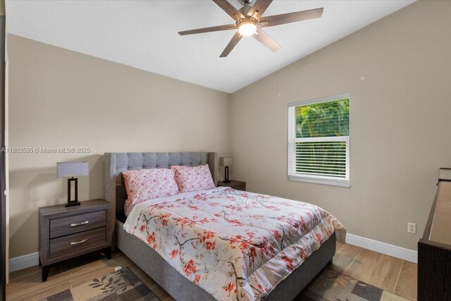 112 SW N Danville Cir, Port St Lucie, FL 34953 - bedroom with wood finished floors, baseboards, lofted ceiling, and ceiling fan