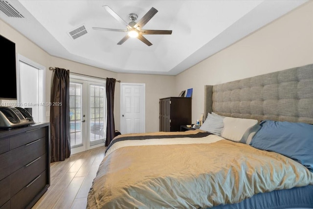 112 SW N Danville Cir, Port St Lucie, FL 34953 - bedroom with access to outside, light wood finished floors, a tray ceiling, and a ceiling fan