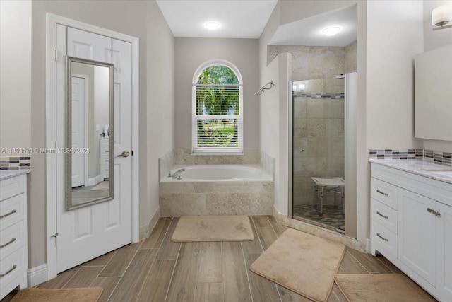 112 SW N Danville Cir, Port St Lucie, FL 34953 - full bathroom with vanity, a shower stall, a bath, and wood tiled floors