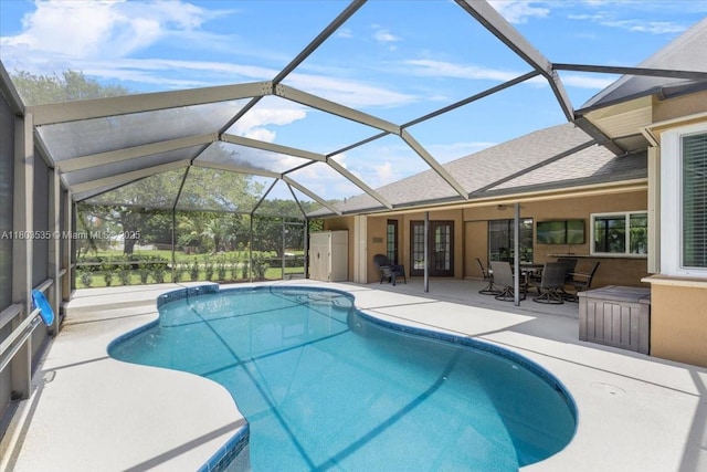 112 SW N Danville Cir, Port St Lucie, FL 34953 - swimming pool featuring a patio area, glass enclosure, and outdoor dining area