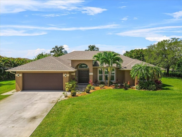 112 SW N Danville Cir, Port St Lucie, FL 34953 - mediterranean / spanish-style home featuring an attached garage, stucco siding, concrete driveway, and a front yard