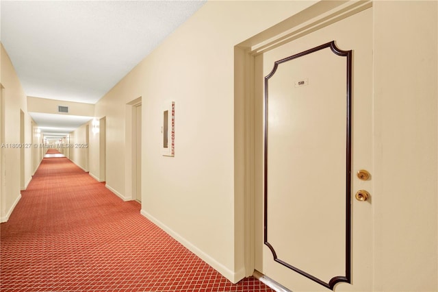 hall with carpet floors and baseboards