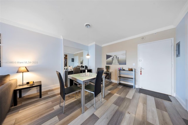 400 Kings Point Dr Unit 1021, Sunny Isles Beach, FL 33160 - dining room with wood finished floors, crown molding, and baseboards