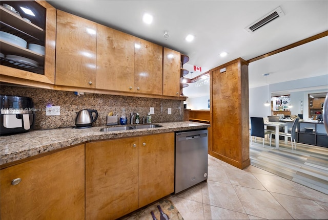 400 Kings Point Dr Unit 1021, Sunny Isles Beach, FL 33160 - kitchen with stainless steel dishwasher, a sink, tasteful backsplash, light stone counters, and light tile patterned floors