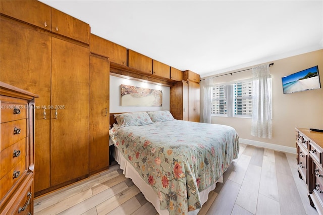400 Kings Point Dr Unit 1021, Sunny Isles Beach, FL 33160 - bedroom featuring light wood-style flooring and baseboards