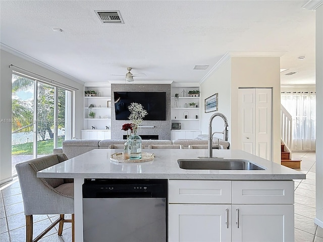 16435 SW 27th St, Miramar, FL 33027 - kitchen featuring dishwasher, a sink, built in shelves, ornamental molding, and a center island with sink